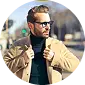Headshot of a man in a tan jacket